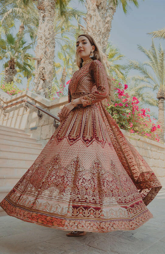 Red Pishwas online USA -Flowing skirt flare of deep red Anarkali pishwas with embellishments.