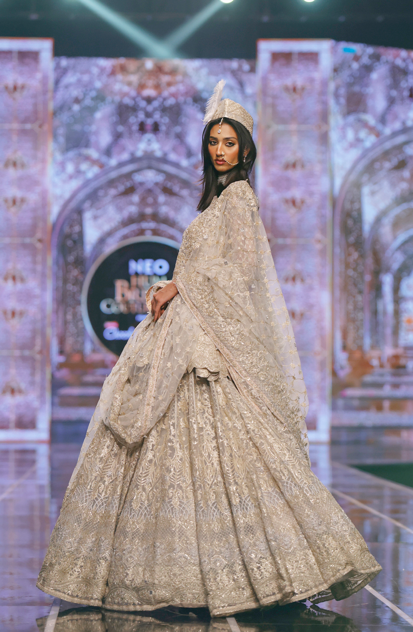 BCW-02 - Net Peplum Lehenga Ensemble-Side profile of BCW-02 net peplum lehenga highlighting graceful drape.