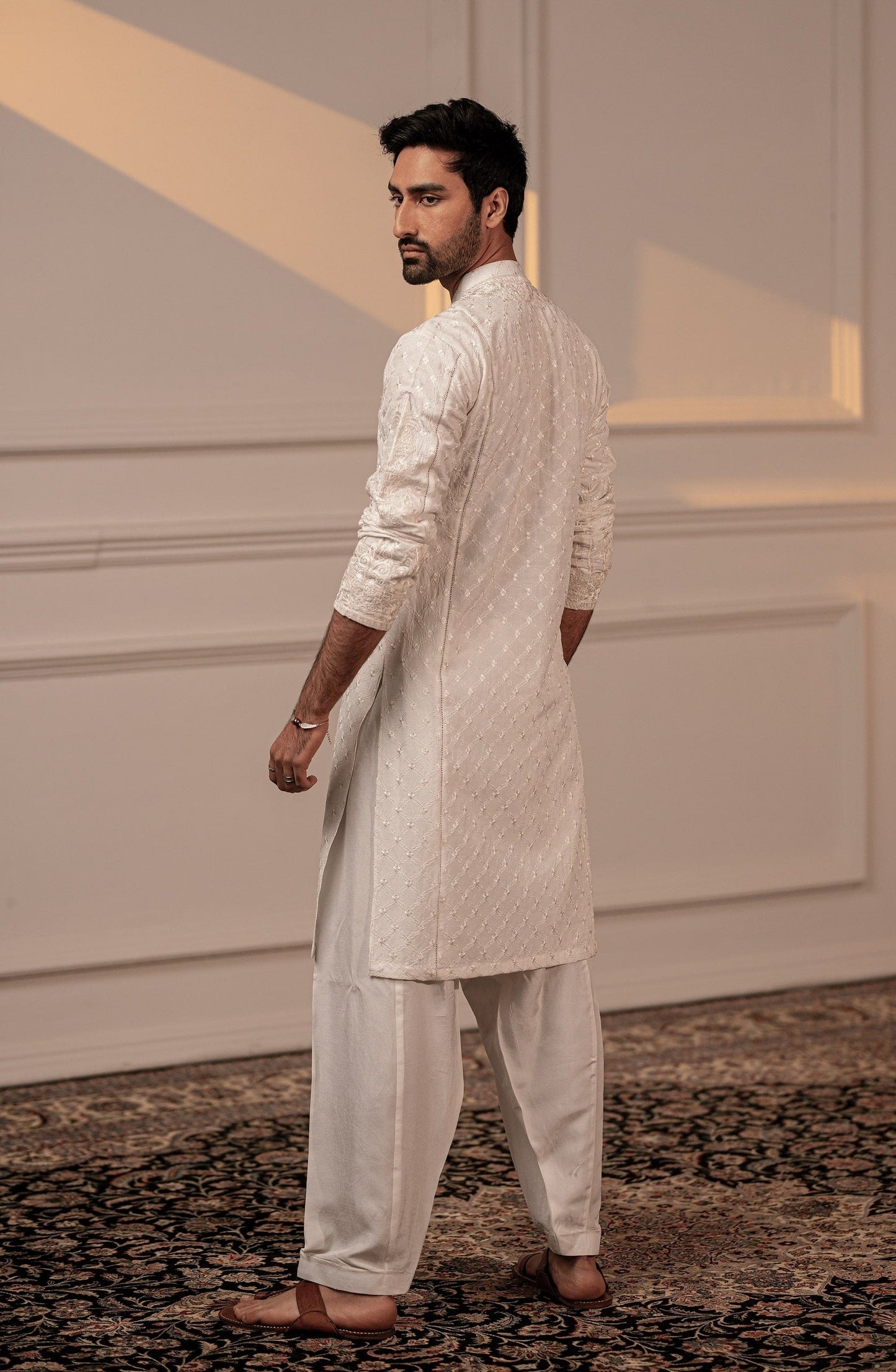Buy traditional Pakistani kurta for men online-Back design of Classic White embroidered male kurta shalwar set.