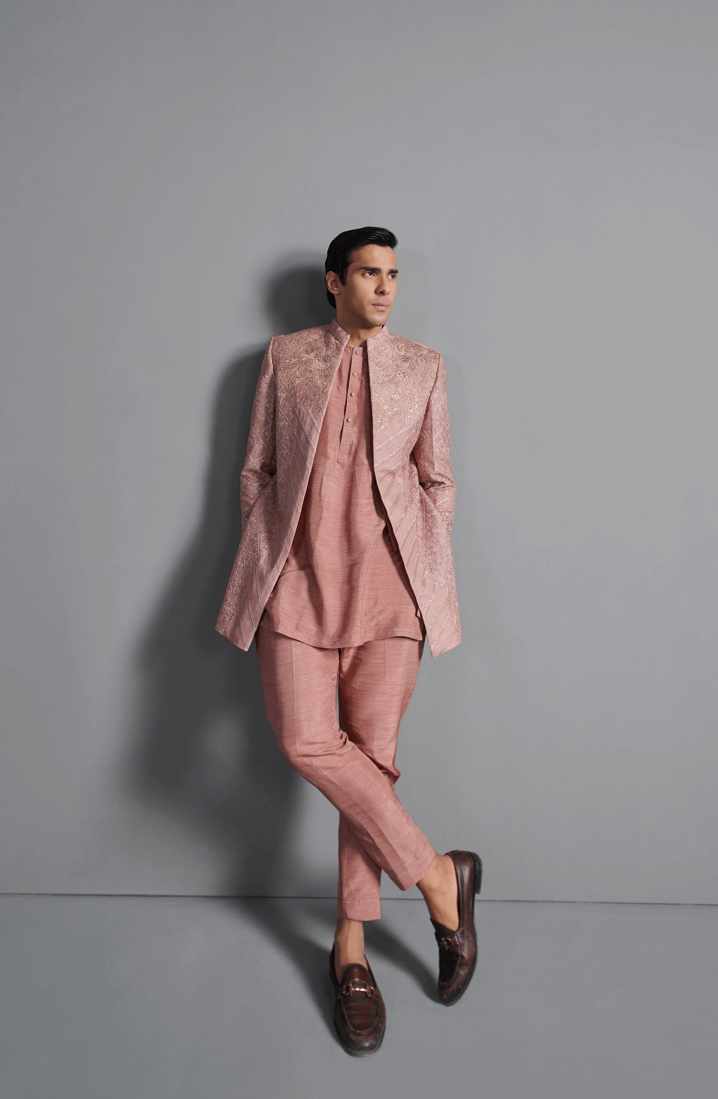 Royal sherwani designs for men-Full outfit of coral pink cotton net short sherwani paired with matching bottoms.
