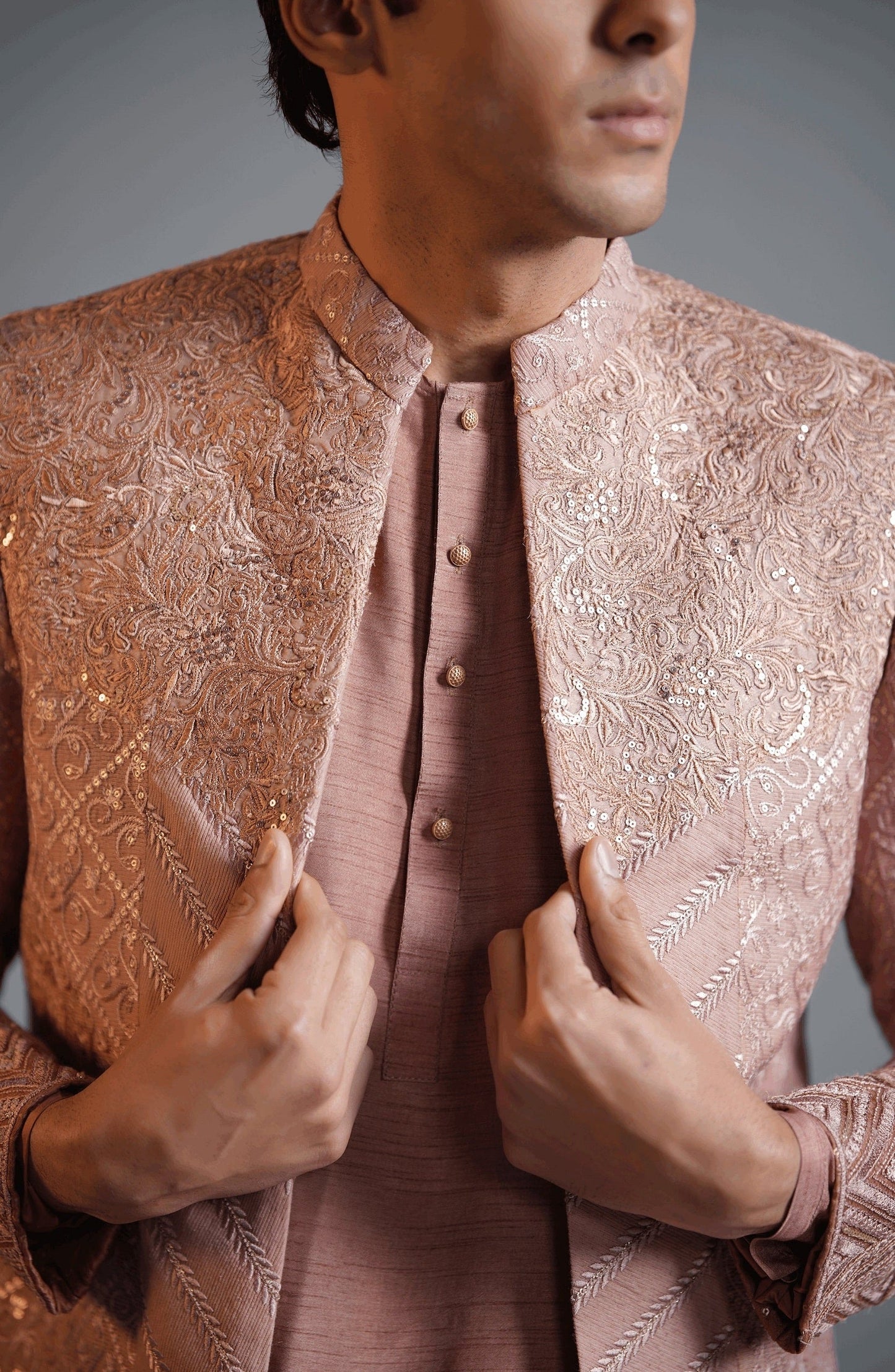 Find stylish sherwanis for men’s weddings-Stylish neckline design of coral pink cotton net sherwani with intricate work.