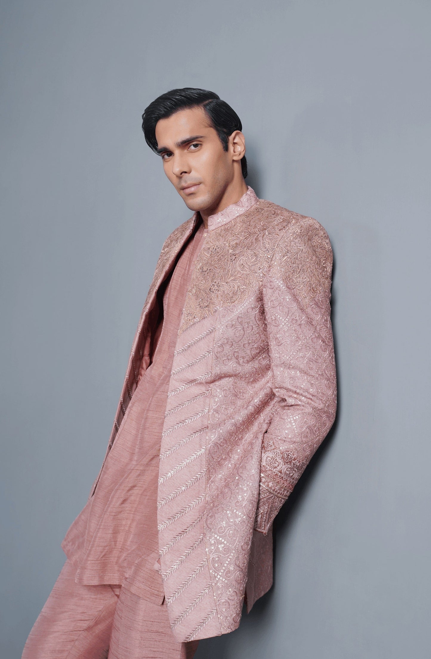 HSY Trousseau Sherwani for grooms -Detailed view of sleeves on coral pink cotton net sherwani set.