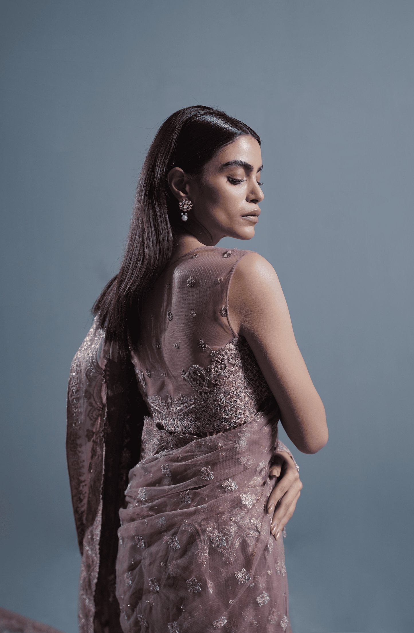 Dusty Rose Pakistani Saree designs in trend-Closeup view of rich embroidery and handcrafted details on net saree.