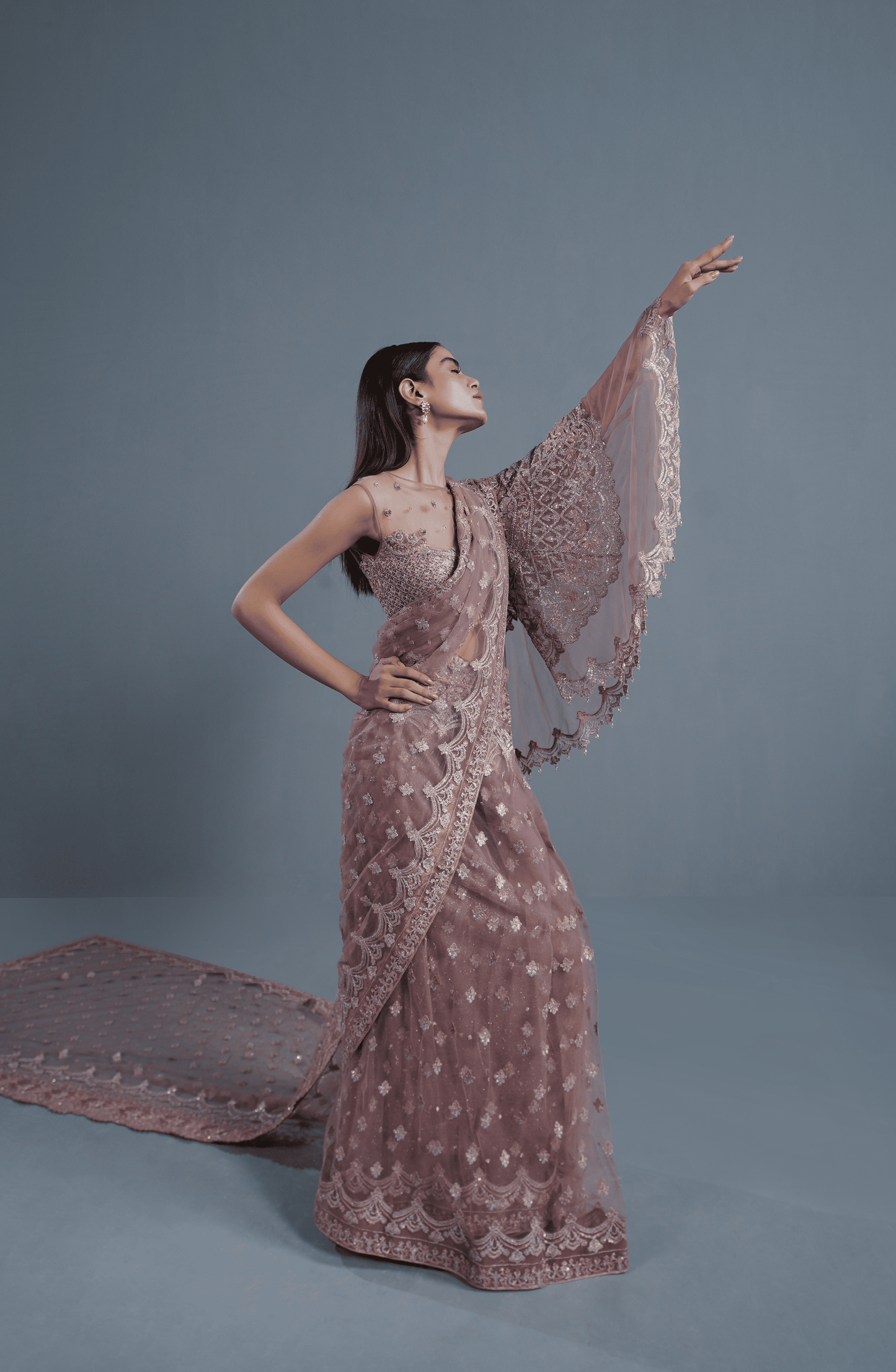 Dusty Rose Pakistani designer Saree online-Complete outfit featuring dusty rose embroidered net saree with matching accessories.