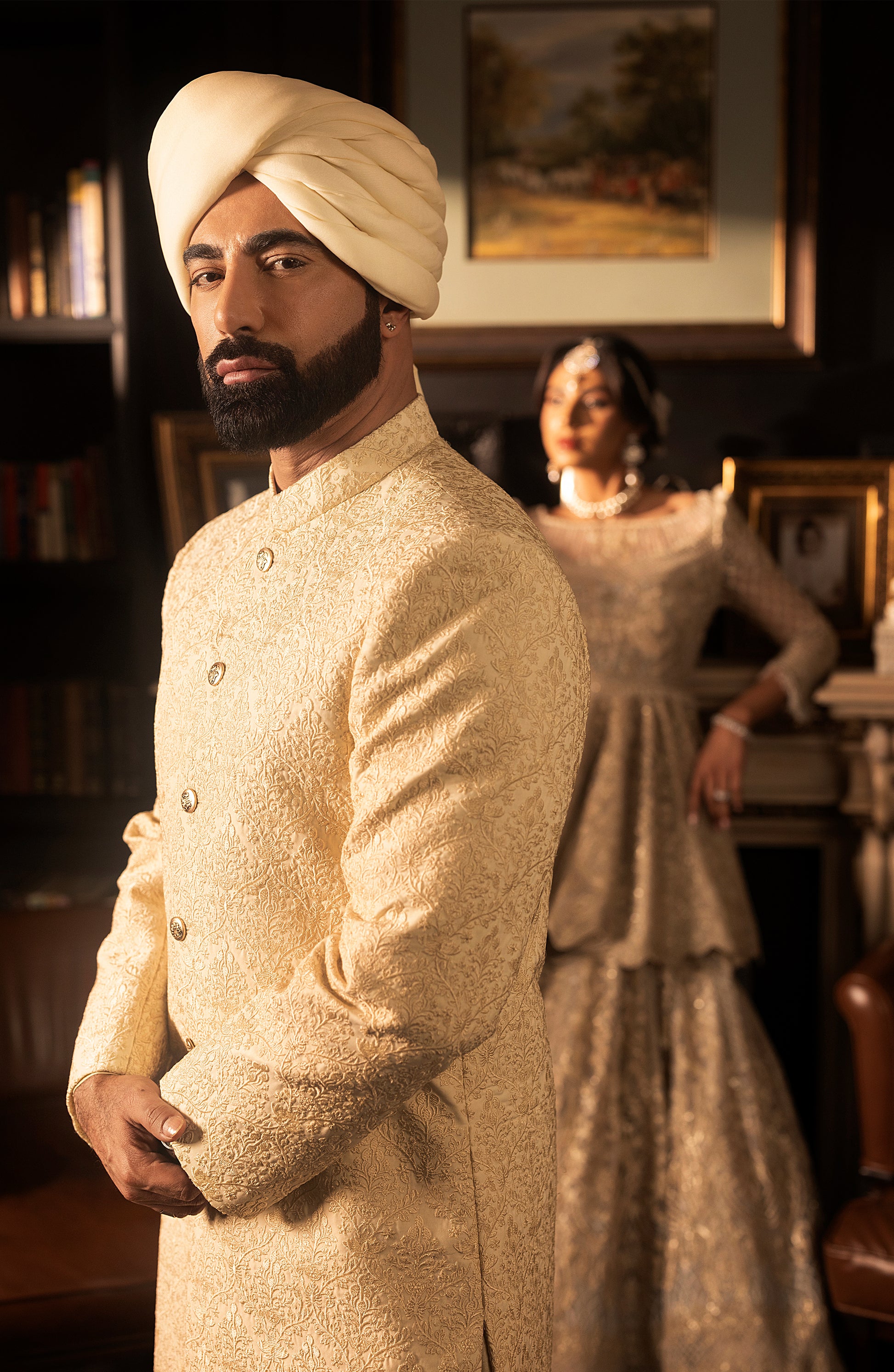 Front view of ivory silk sherwani with gold button detailing