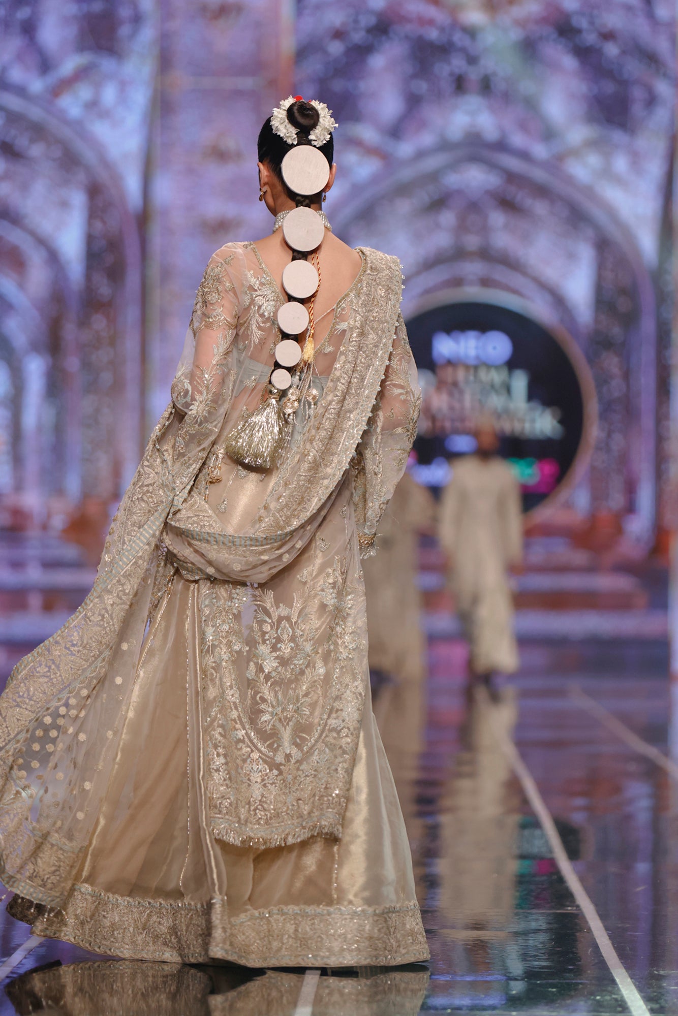 Pakistani bridal sharara style by top designer HSY -Back design of long net shirt paired with elegant tissue sharara