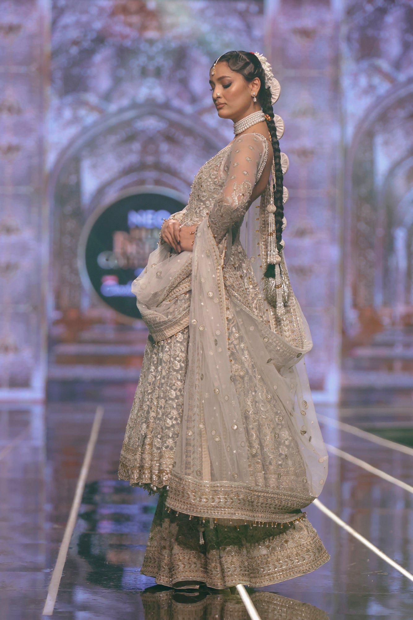 Pakistani designer Net pishwas paired with jamawar sharara-Side profile of traditional net pishwas with embroidered jamawar sharara