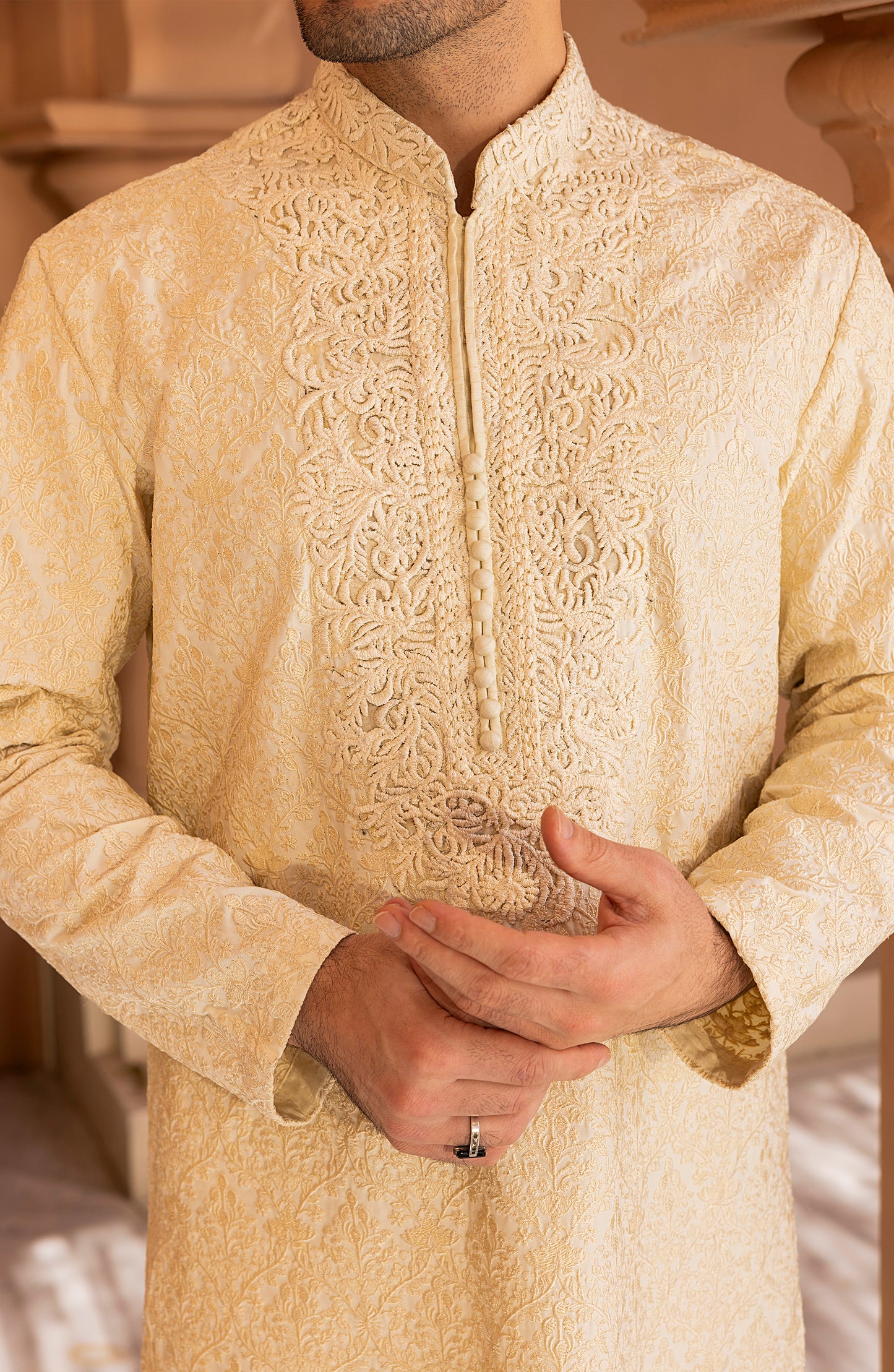 Detailed embroidery work on pearl white kurta churidaar dress
