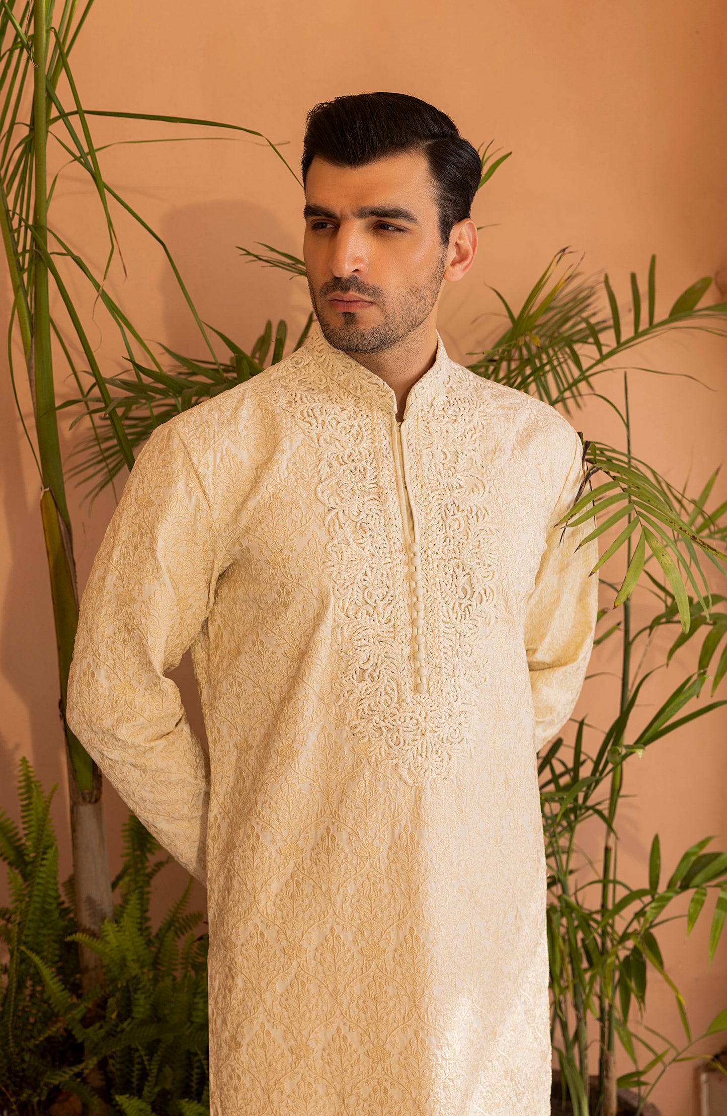 Side profile of pearl white embroidered kurta with churidaar