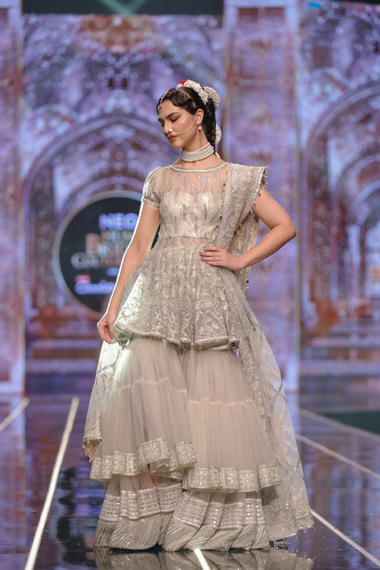 HSY Peplum Top With Tiered Gharara-Side profile of elegant peplum top with tiered gharara outfit