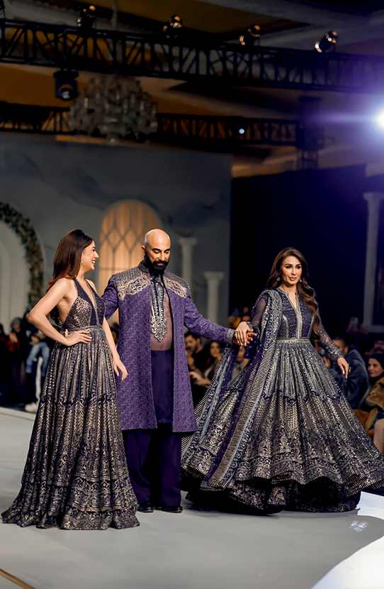 HSY Featuring Reema Khan and Mehwish Hayat-Side profile of royal purple gown set with flowing silhouette