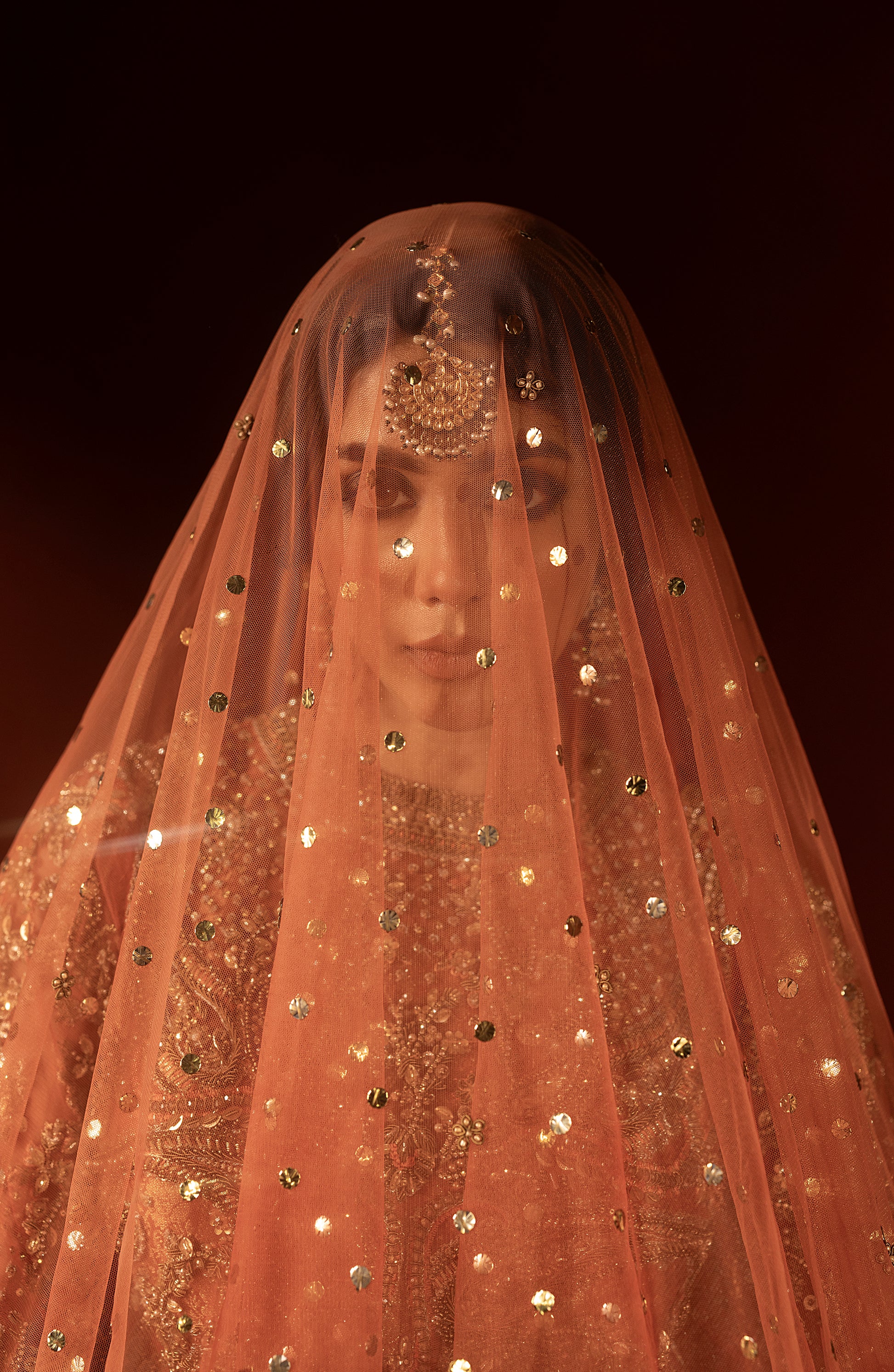 Bridal dupatta styling with rust orange pishwas lehenga set