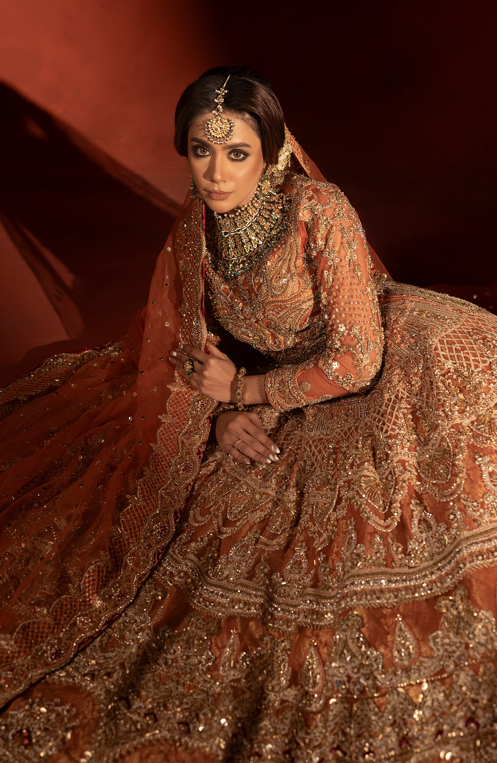 Traditional rust orange jamawar lehenga with pishwas design