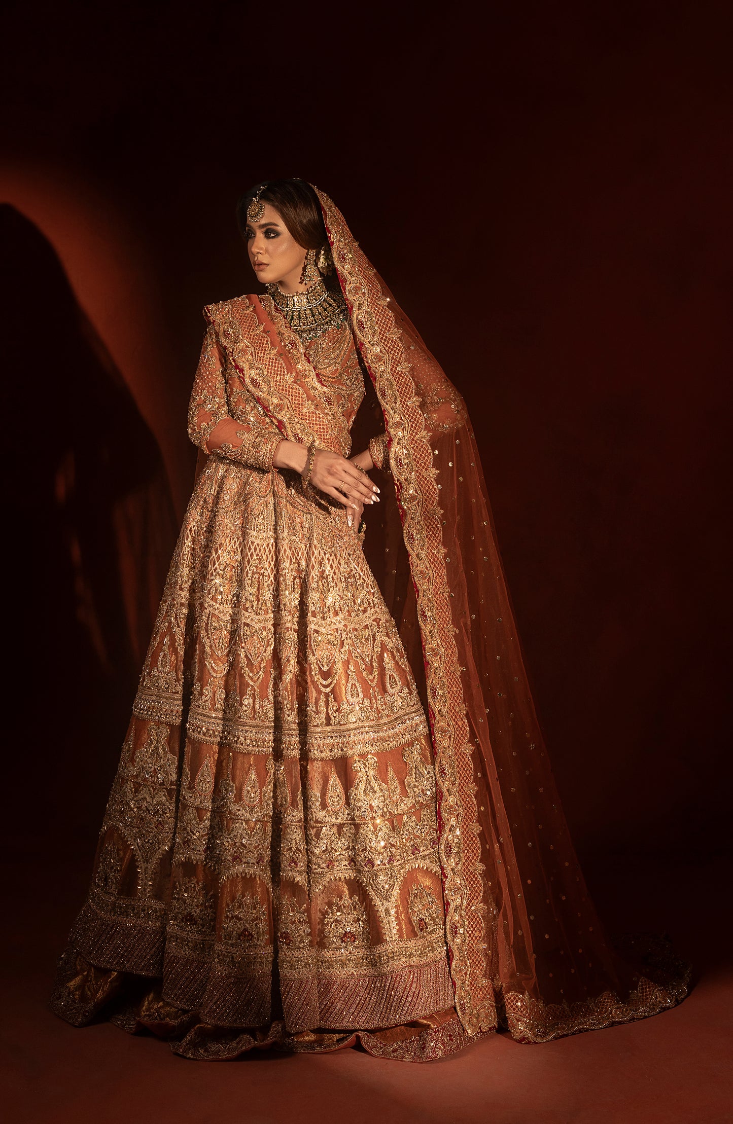 Embroidery detail on rust orange pishwas jamawar lehenga set