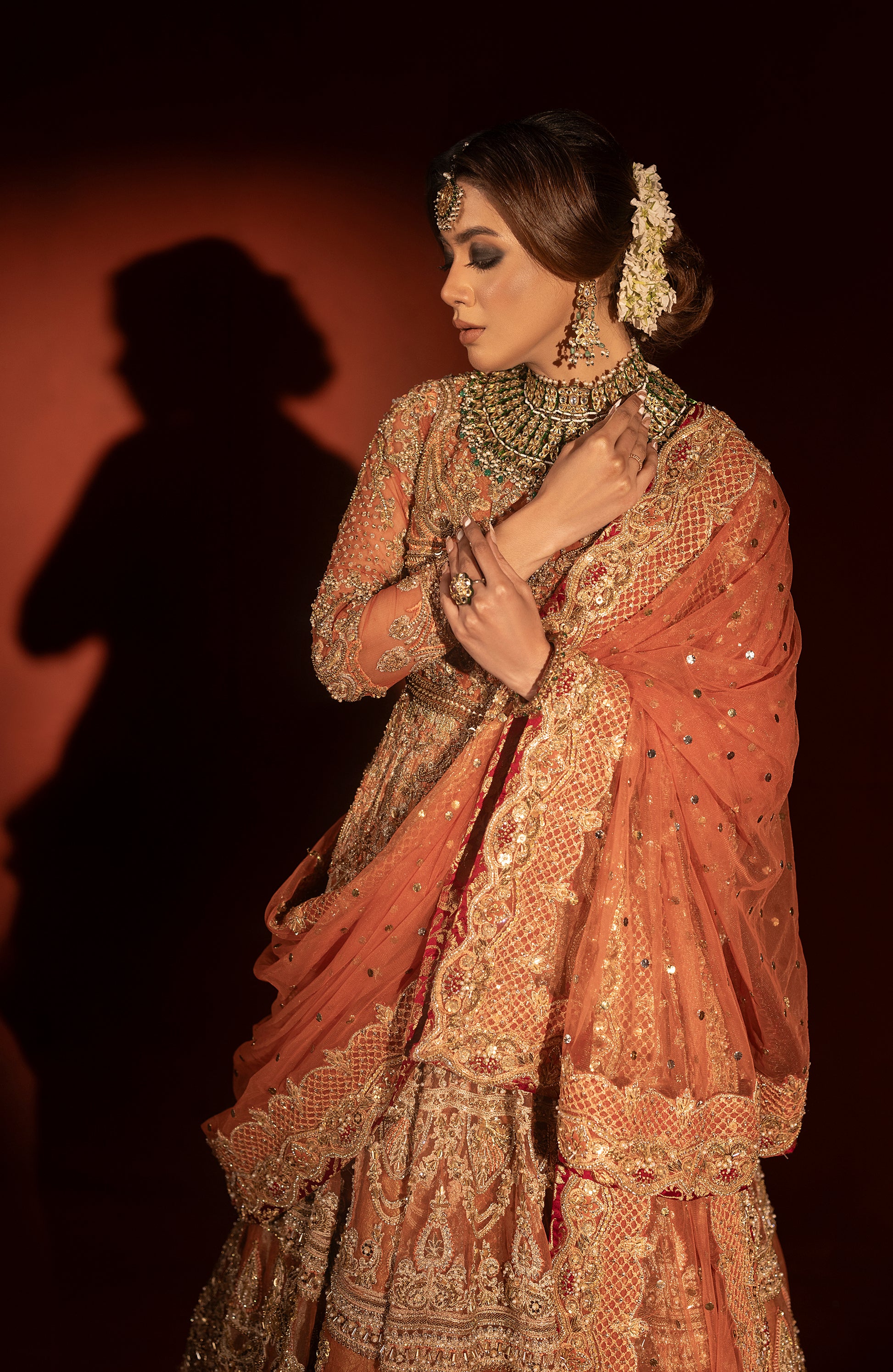 Front view of rust orange pishwas with jamawar lehenga set