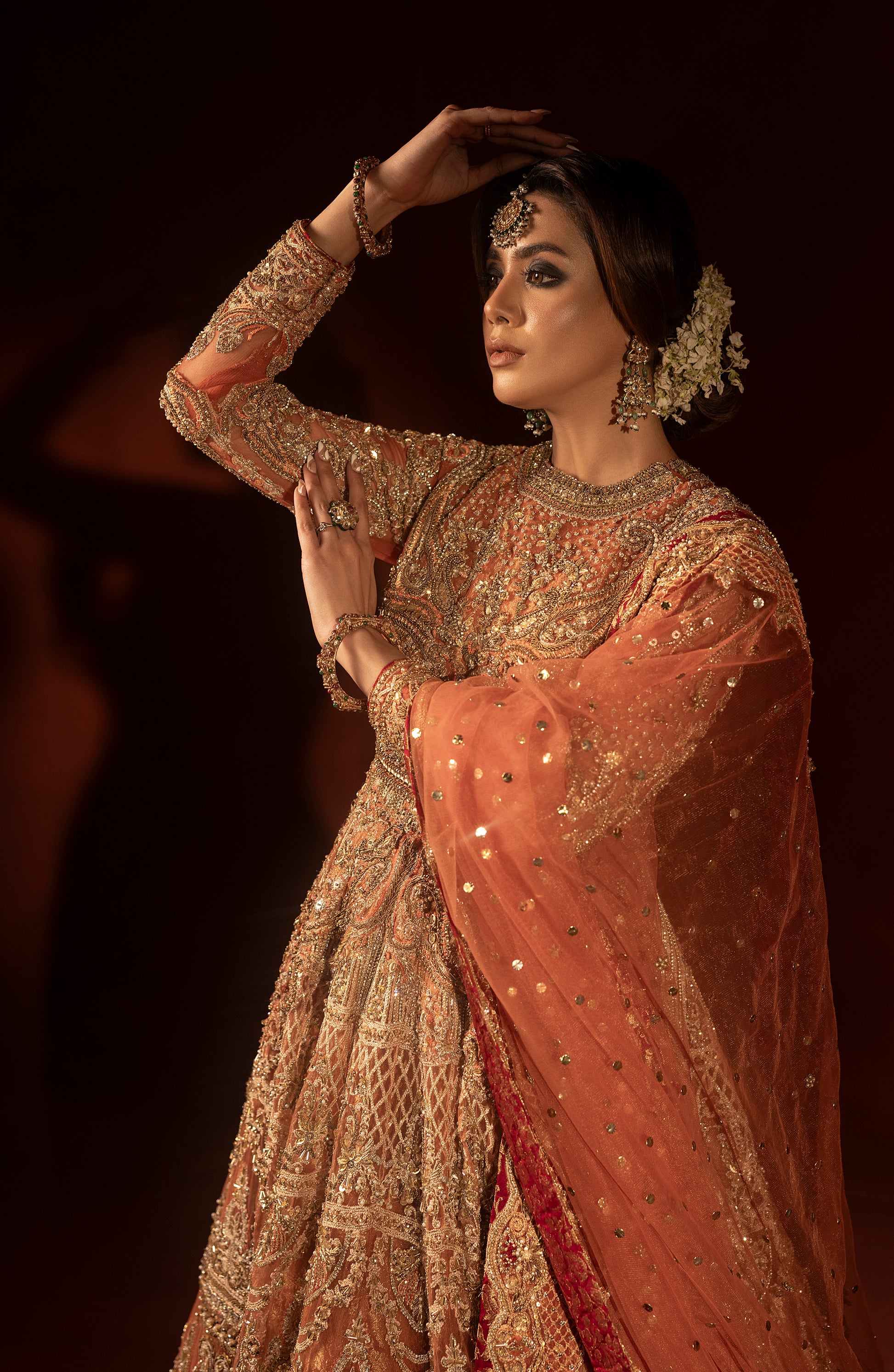 Sleeve design detail of rust orange bridal pishwas lehenga