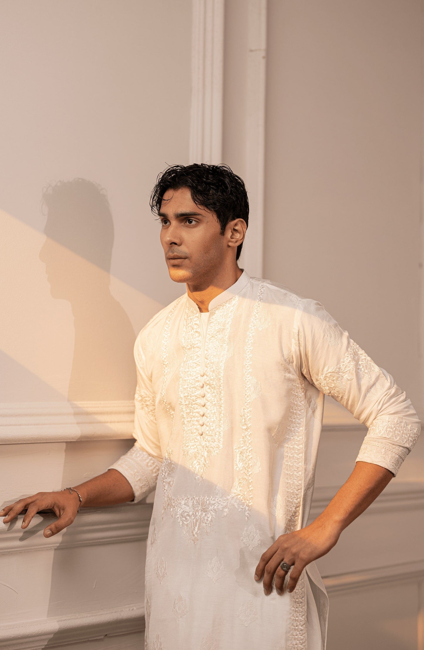 Buy men’s Pakistani kurtas in latest designs-Closeup embroidery work on Timeless White silk kurta shalwar outfit.