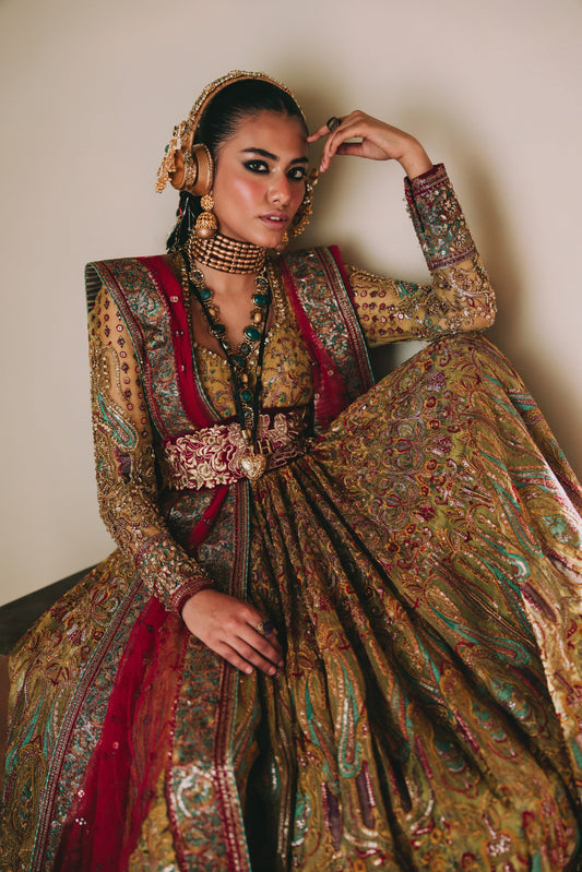 Woman in an ornate traditional outfit with intricate patterns and jewelry.