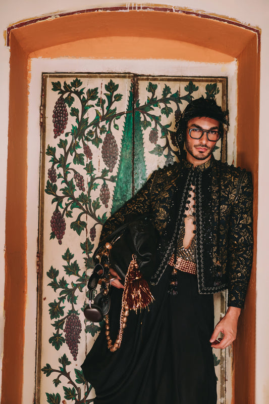 Man in an ornate jacket standing in front of a decorative door