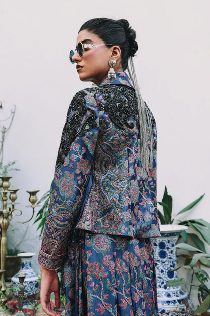 Woman wearing a patterned outfit with sunglasses in an indoor setting