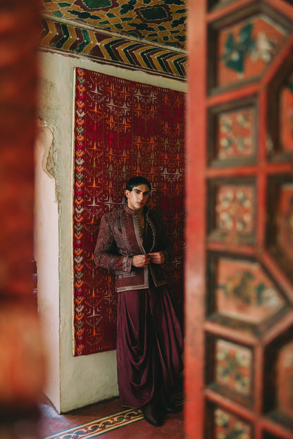 Woman in a purple dress standing in a room with ornate decor