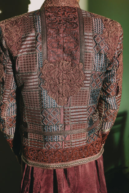 Patterned garment with intricate designs on a dark background