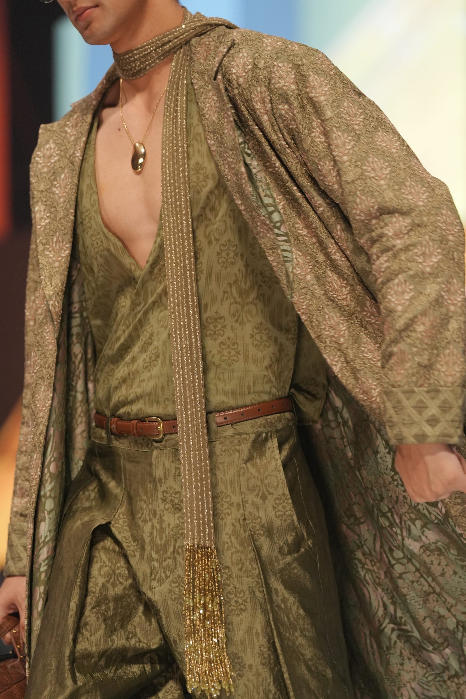 Man wearing a detailed robe with a patterned design