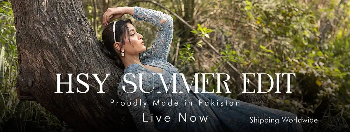 Woman in a blue dress leaning against a tree with 'HSY Summer Edit' text overlay.