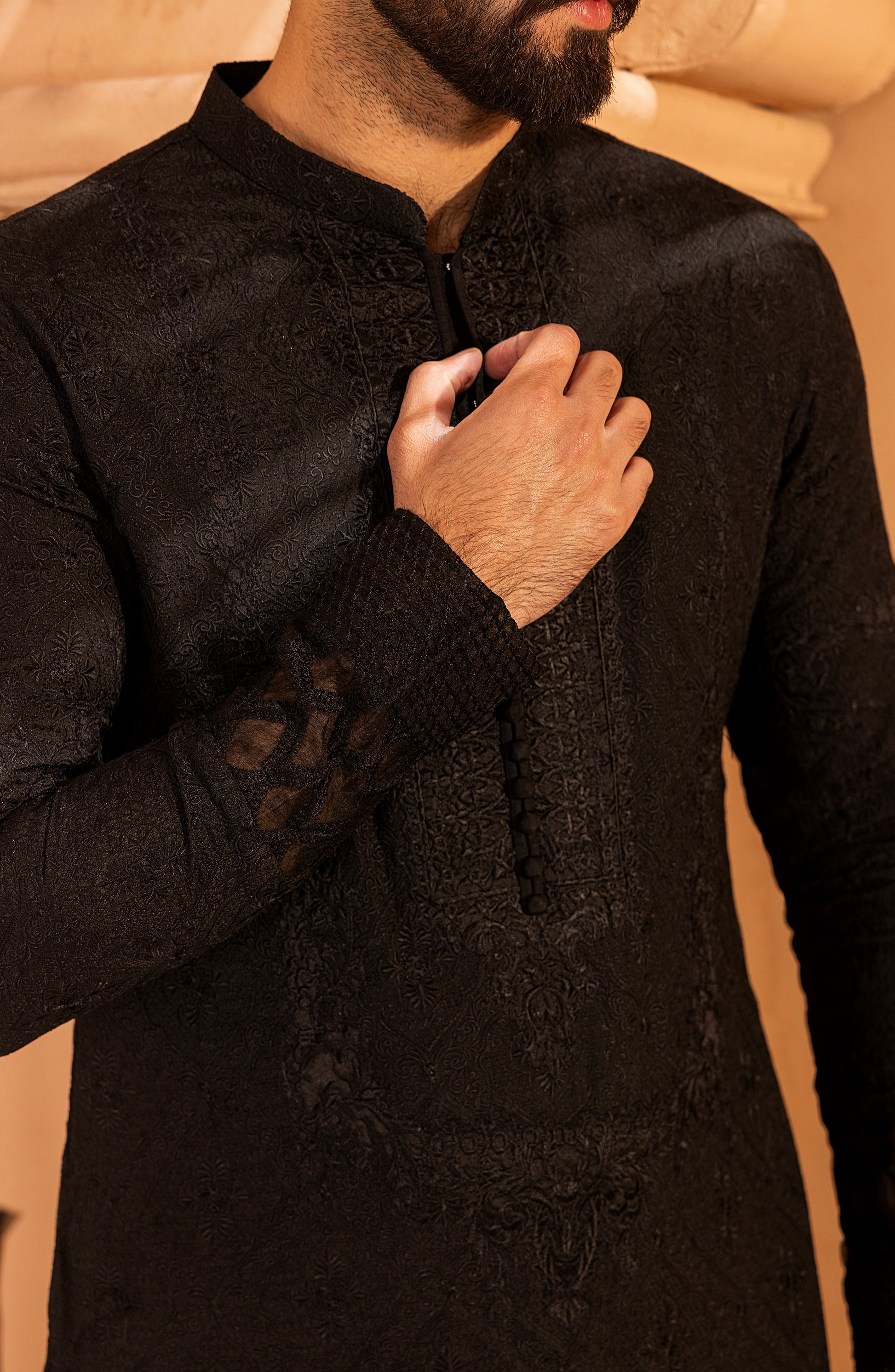 Closeup of embroidery on black kurta shalwar kameez