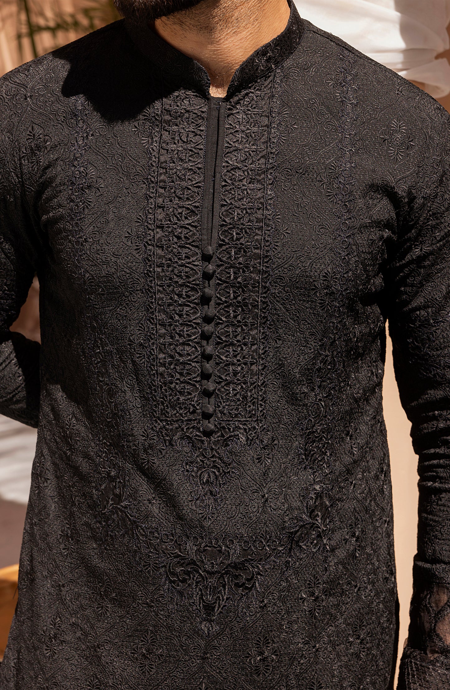 Detailed embroidery work on black kurta shalwar kameez outfit