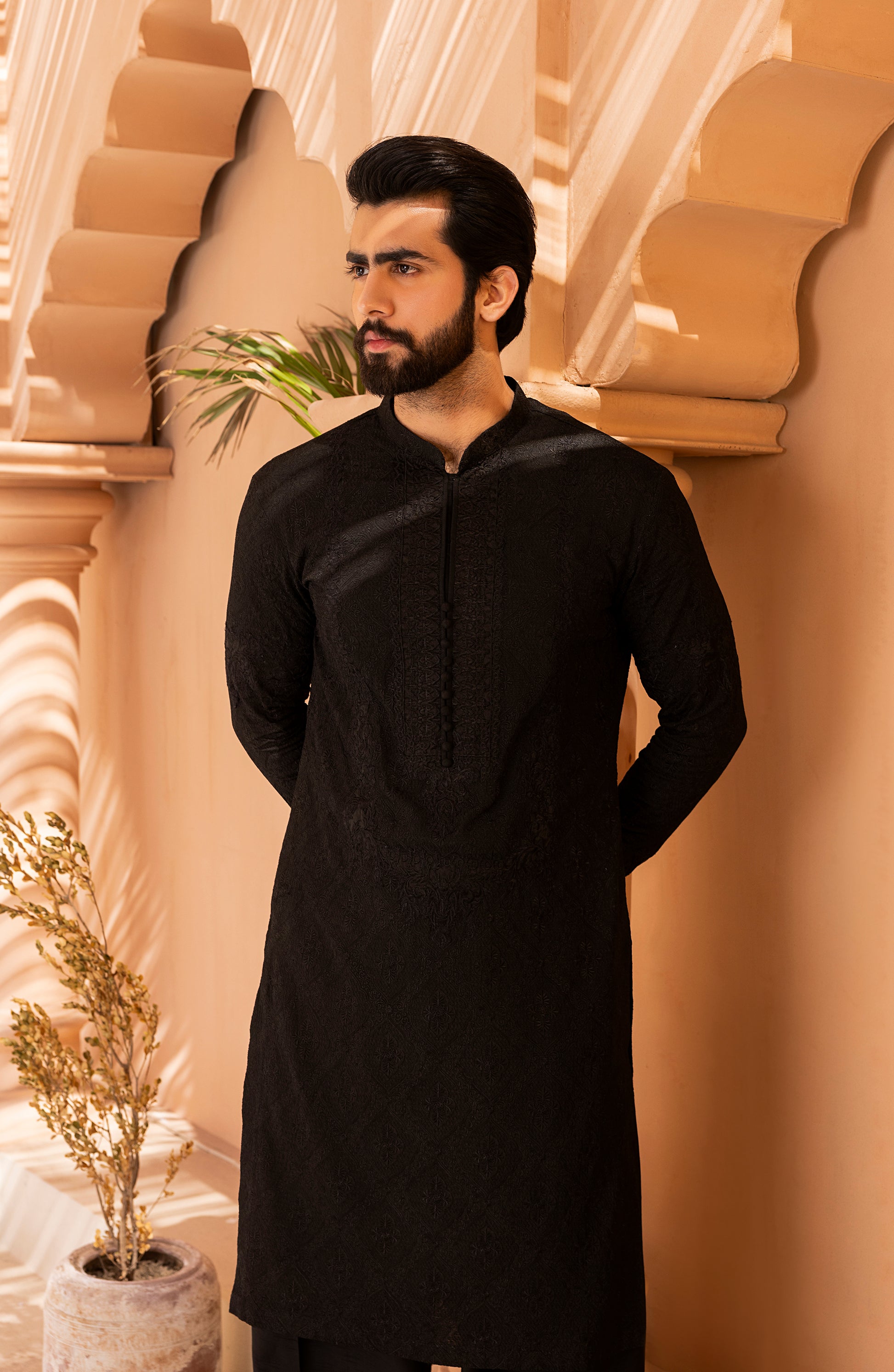 Full outfit view of black embroidered kurta and shalwar kameez