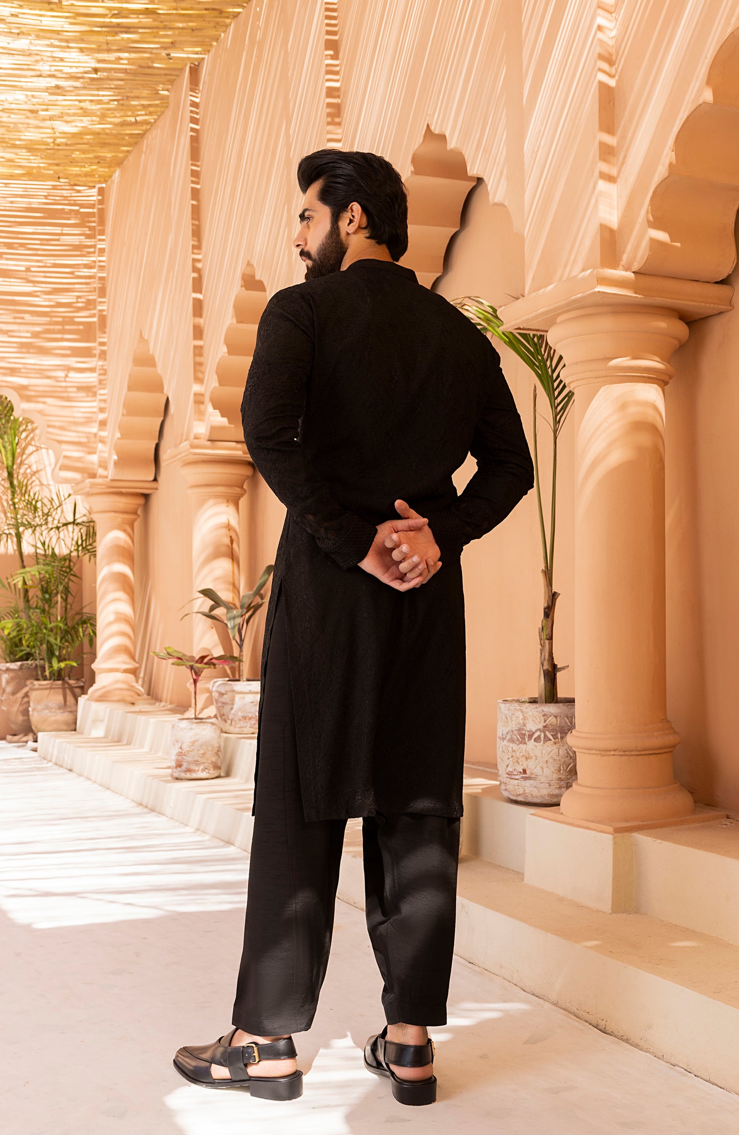 Side profile of black traditional embroidered kurta shalwar