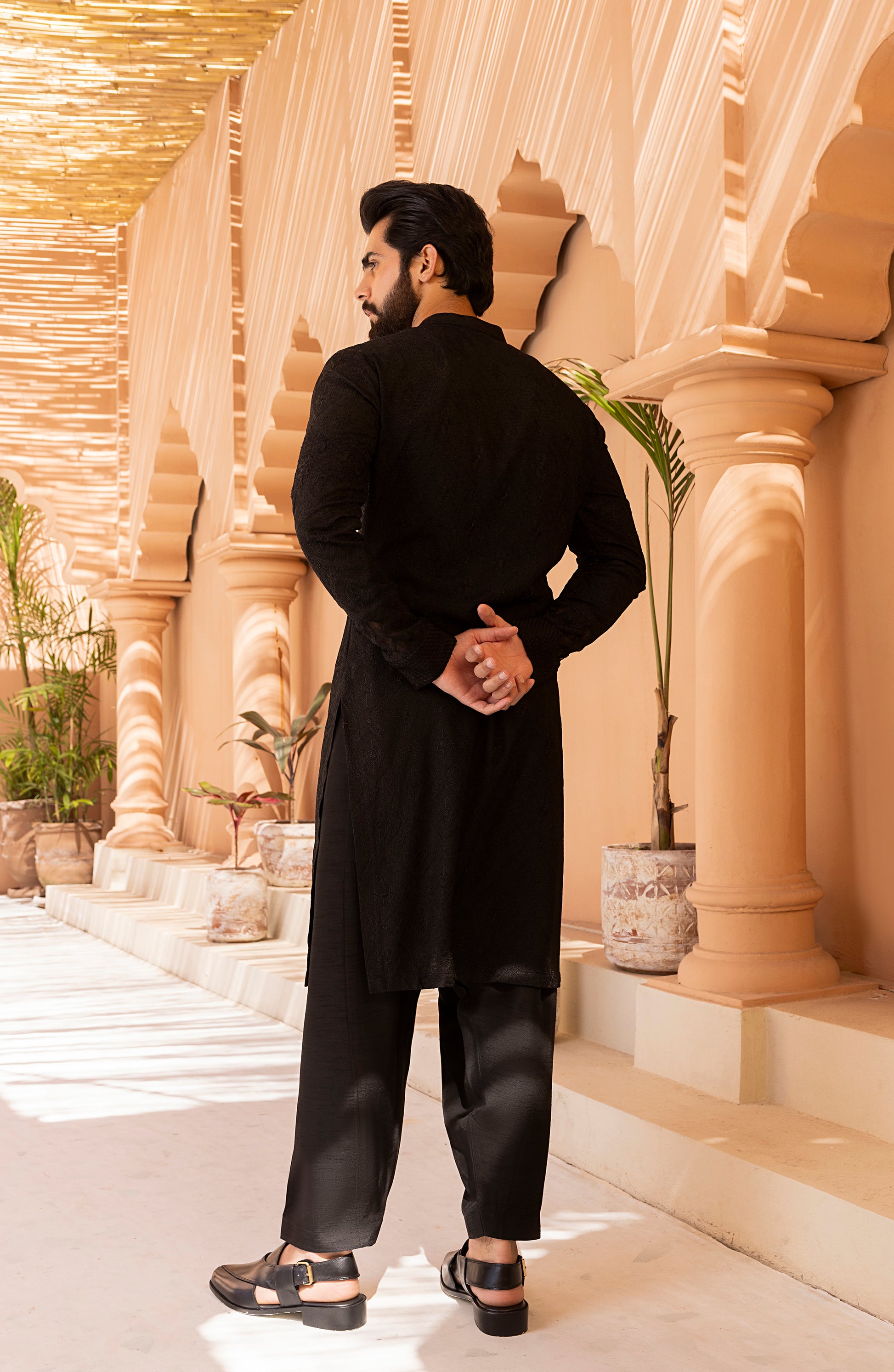 Side profile of black traditional embroidered kurta shalwar