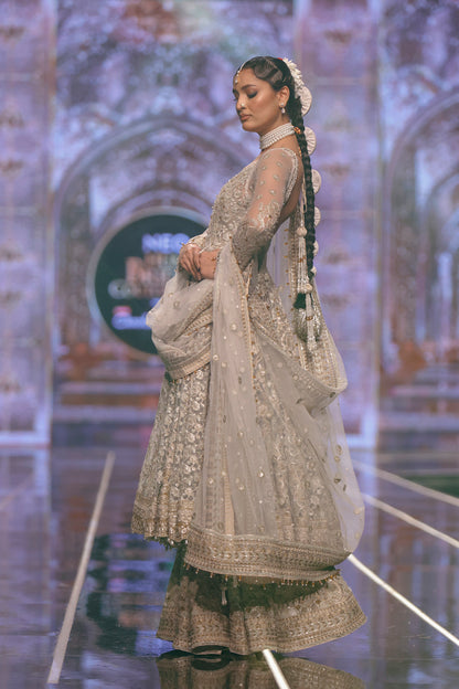 Pakistani designer Net pishwas paired with jamawar sharara-Side profile of traditional net pishwas with embroidered jamawar sharara