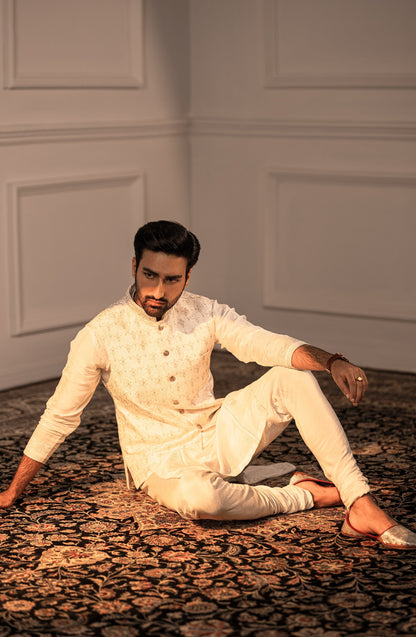 Pakistani designer kurta for men-Intricate handwork closeup on Opulent White embroidered silk kurta.