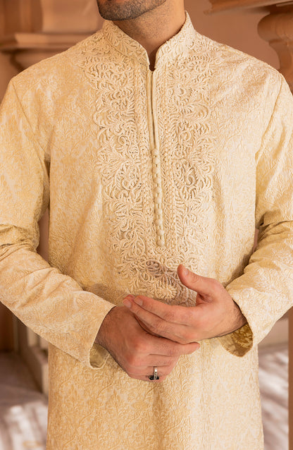 Detailed embroidery work on pearl white kurta churidaar dress