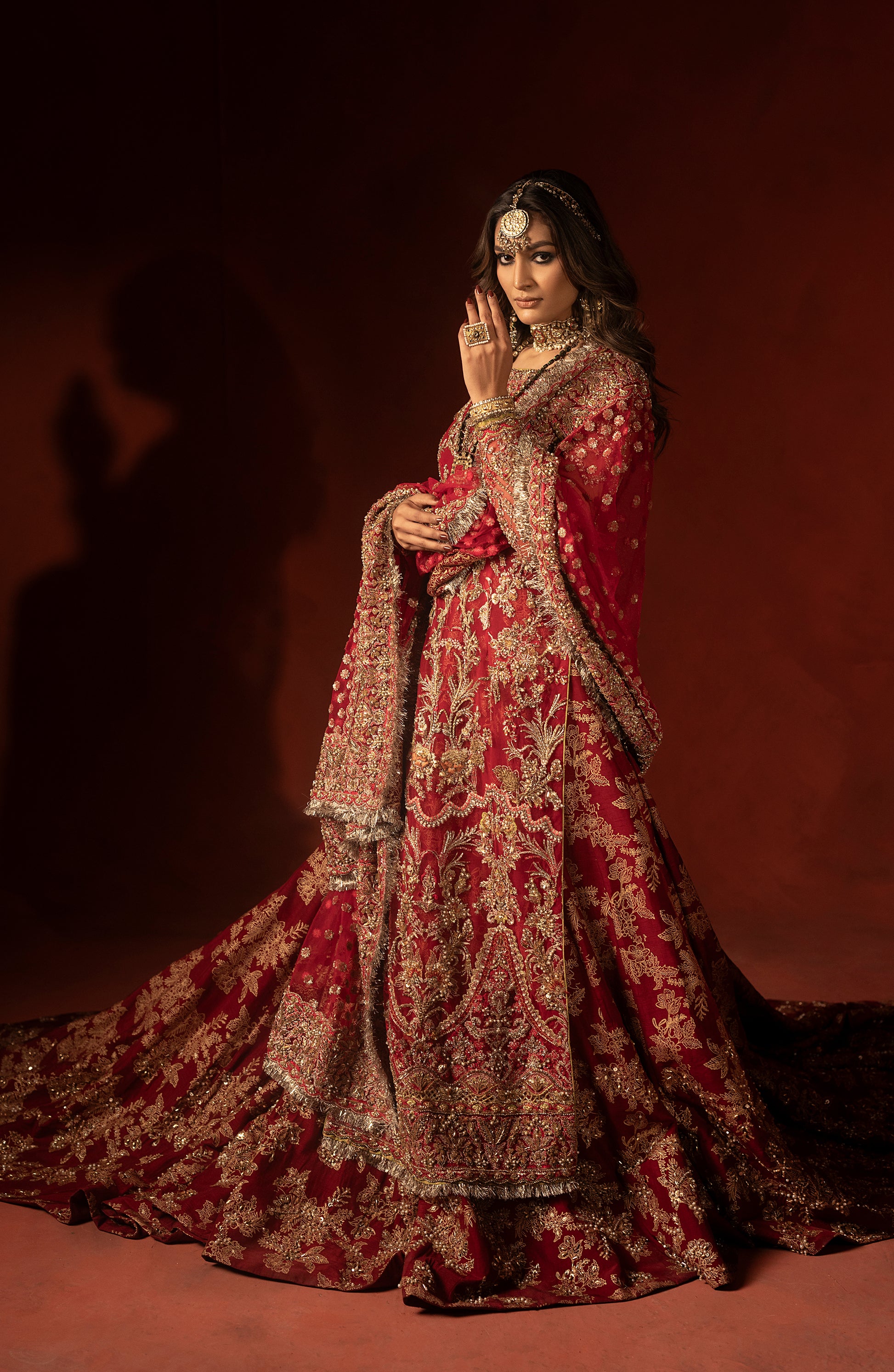 Closeup of raspberry red bridal lehenga fabric and detailing