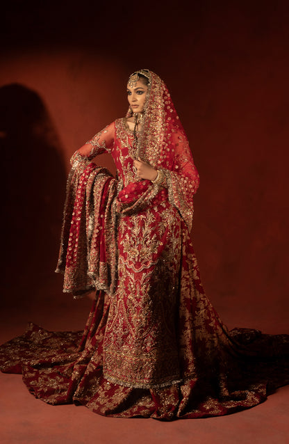Model showcasing back view of raspberry red wedding lehenga