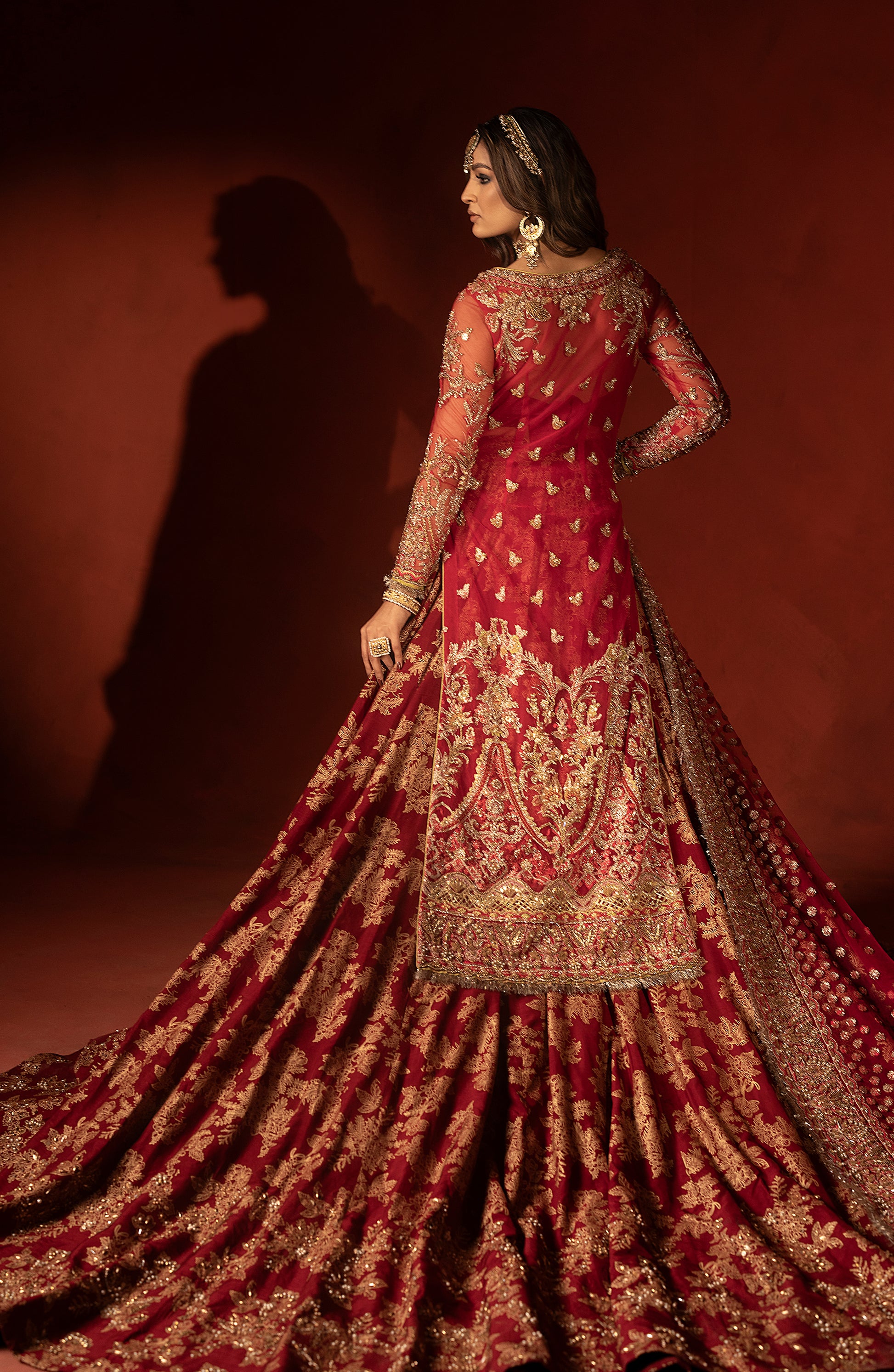 Side profile of raspberry red wedding lehenga set with dupatta