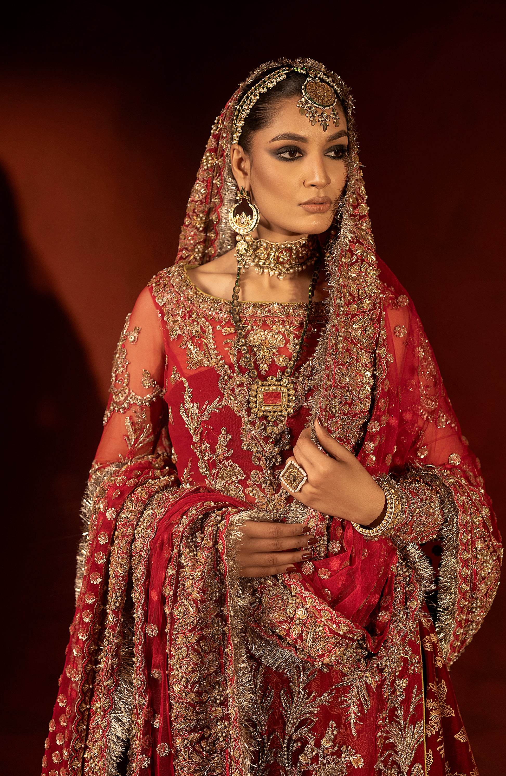 Model wearing raspberry red bridal lehenga set front pose