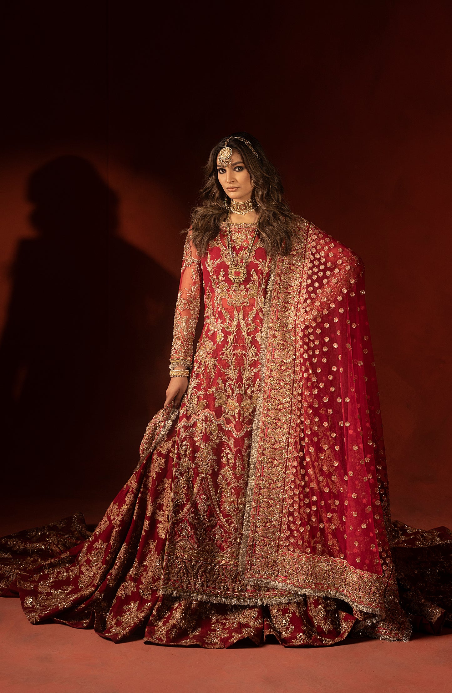 Designer raspberry red wedding lehenga set with embroidered trail