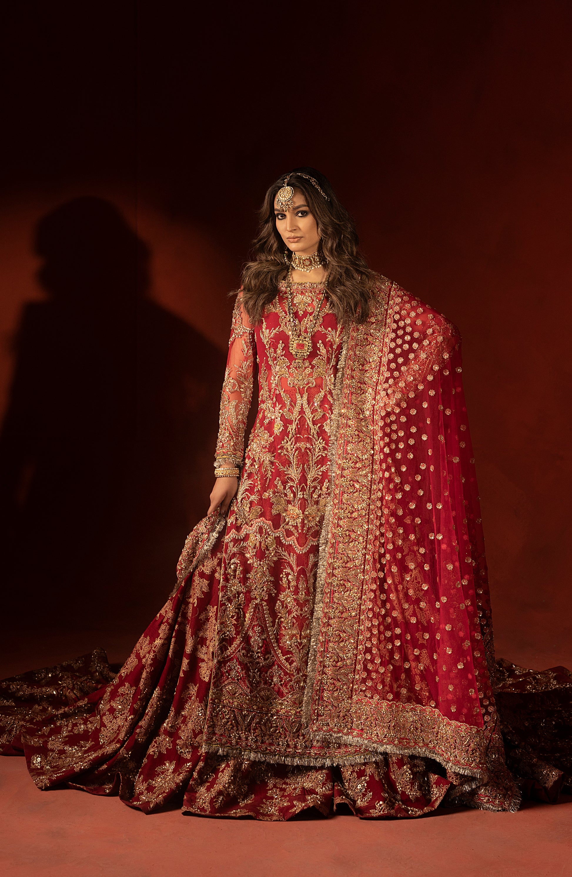 Designer raspberry red wedding lehenga set with embroidered trail