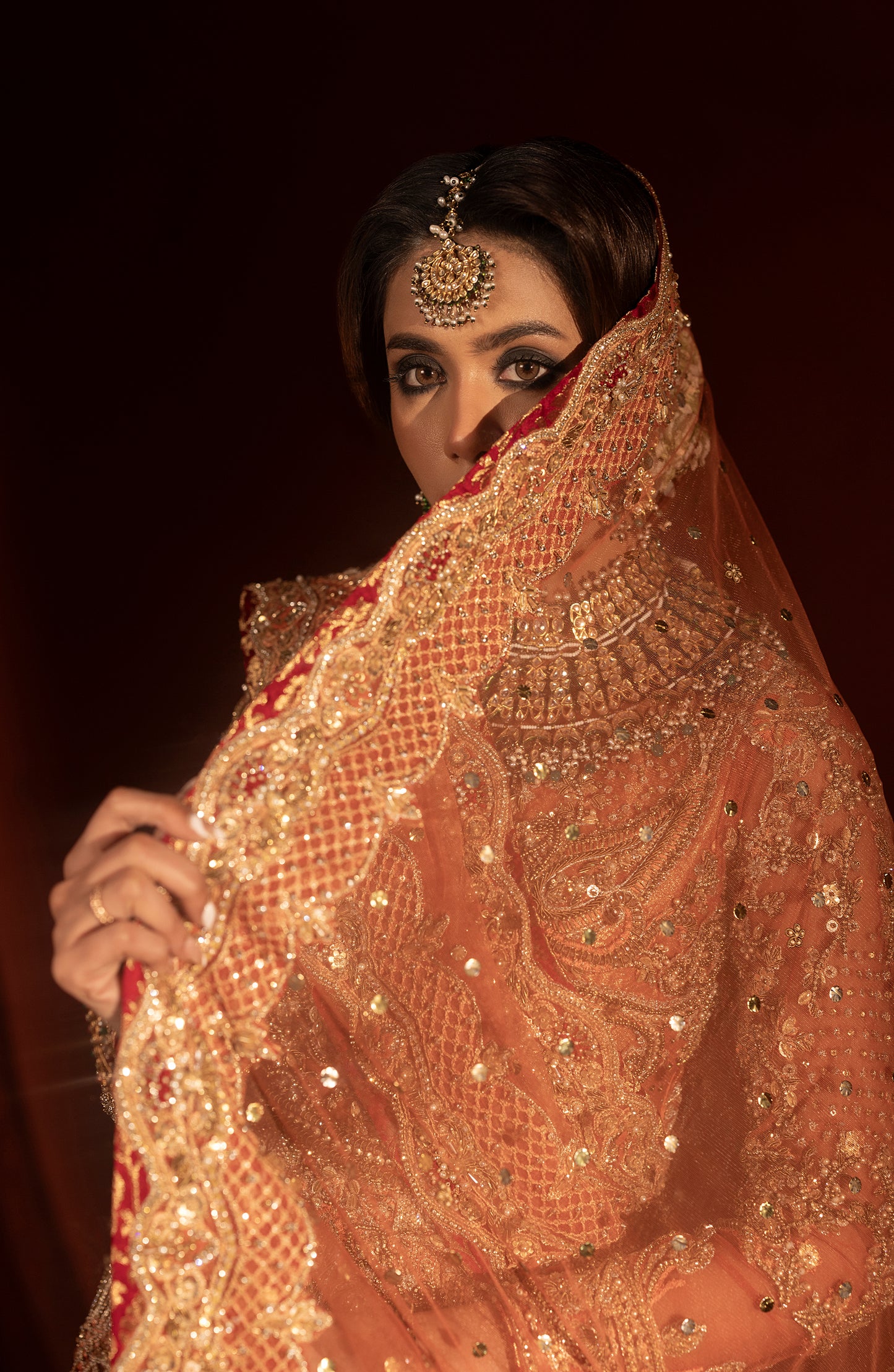Blouse design of rust orange jamawar lehenga set