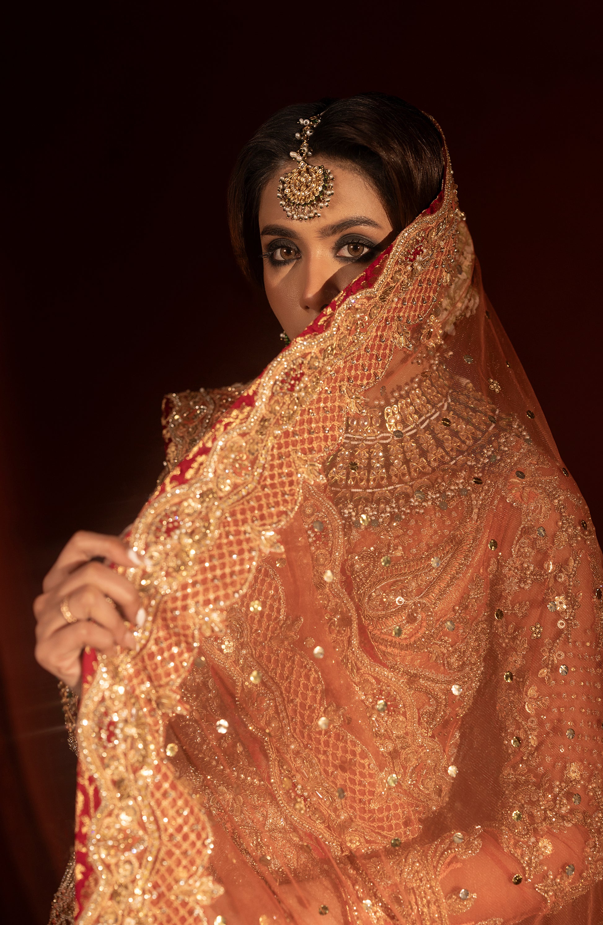 Blouse design of rust orange jamawar lehenga set