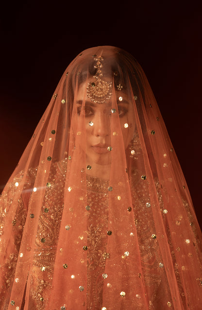 Bridal dupatta styling with rust orange pishwas lehenga set