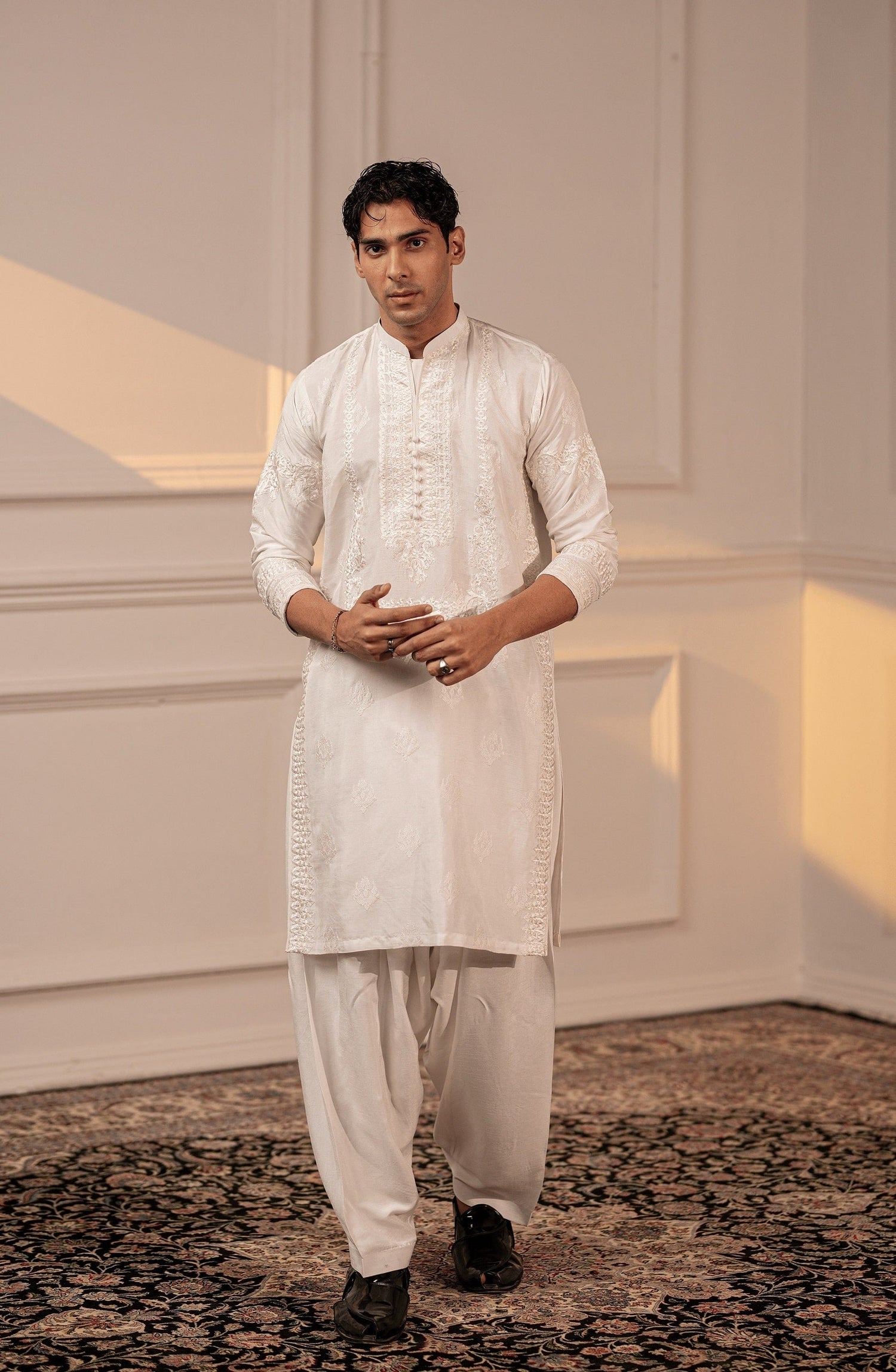 Shop luxury Pakistani kurta designs for men-Elegant Timeless White silk kurta shalwar with fine embroidery, front view.